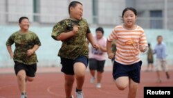 FILE - Children exercise during a weight-losing summer camp in Shenyang, Liaoning province, China.