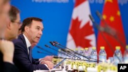 FILE - Canadian Finance Minister Bill Morneau speaks at the first China-Canada economic and financial strategy dialogue in Beijing, Nov. 12, 2018. 
