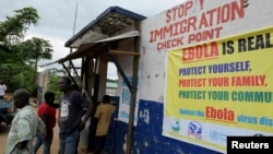 Liberian soldiers check people traveling in Bomi County, Aug. 11, 2014. 