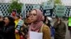 Isra Ayesh, center, of Seattle, who is the organizing director of Americans for Refugees and Immigrants, waits for her turn to speak during a demonstration against President Donald Trump's revised travel ban outside a federal courthouse in Seattle, May 15, 2017.
