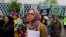 Isra Ayesh, center, of Seattle, who is the organizing director of Americans for Refugees and Immigrants, waits for her turn to speak during a demonstration against President Donald Trump's revised travel ban outside a federal courthouse in Seattle, May 15, 2017.