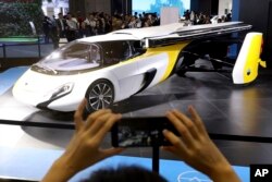 A visitor takes a photo of the Aeromobil, a flying car from Slovakia, during the China International Import Expo in Shanghai, Nov. 5, 2018.