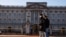 People wearing face masks walk past Buckingham Palace amid the COVID-19 outbreak, in London, Britain, Jan. 22, 2021.