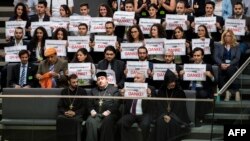 Activists and the leader of the Anerkennung Jetzt (Recognition Now) civil society initiative, Ilias Uyar (bottom, 2nd R), react after German lawmakers voted to recognize the Armenian genocide after a debate in the Bundestag, in Berlin, June 2, 2016.