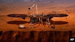 This illustration made available by NASA in 2018 shows the InSight lander drilling into Mars. InSight, short for Interior Exploration using Seismic Investigations, Geodesy and Heat Transport, launched from Vandenberg Air Force Base on Saturday, May 5, 201