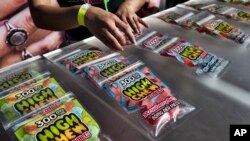 FILE - In this Saturday, Oct. 20, 2018 photo medicated High Chew edibles are shown on display and offered for sale at the cannabis-themed Kushstock Festival at Adelanto, Calif. (AP Photo/Richard Vogel)