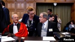 Nicaraguan Ambassador Carlos Jose Arguello Gomez and lawyer Alain Pellet sit in the courtroom, as Nicaragua asks the International Court of Justice to order Berlin to halt military arms exports to Israel, in The Hague, Netherlands, April 8, 2024. 
