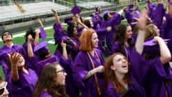 Graduates throw their mortarboards into the air in celebration after receiving their diplomas, following the commencement ceremony at Boulder High School, in Boulder, Colo. on Saturday May 18, 2013. (AP Photo/Brennan Linsley)