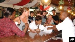 Some of the passengers who were aboard Air France plane arrive at a hotel in Mombasa, Kenya, from Moi international airport Mombasa, Dec. 20, 2015, after their Air France flight from Mauritius to Paris was forced to land in the Kenya because a suspicious