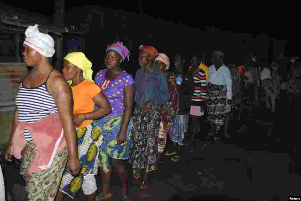 People waiting in line to begin receiving their home disinfectant kits in Monrovia, Liberia, Oct. 20, 2014. 