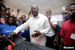 George Weah, former soccer player and presidential candidate of Congress for Democratic Change (CDC), votes at a polling station in Monrovia.
