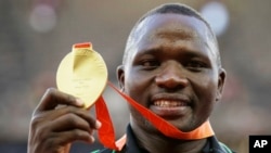 FILE - Javelin gold medalist Kenya's Julius Yego celebrates on the podium at the World Athletics Championships at the Bird's Nest stadium in Beijing, Aug. 27, 2015