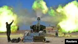 Popular Mobilization Forces (PMF) fire toward Islamic State militants during a battle with west of Mosul, Iraq, Feb. 22, 2017.