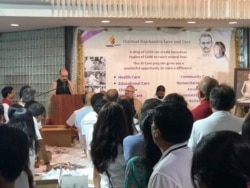 Audience members listen as Indian Ambassador to the U.S. Vardhan Shringla discusses the volunteers’ work and faith. (Photo: Arrington Luck/VOA)