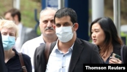 FILE PHOTO: Al Jazeera senior producer Drew Ambrose leaves Bukit Man police headquarters after being questioned by the Malaysian police over a documentary on the country’s arrests of undocumented migrants, in Kuala Lumpur