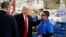 President-elect Donald Trump talks with workers during a visit to the Carrier factory, Dec. 1, 2016, in Indianapolis, Indiana. Trump is warning American businesses they will face a stiff tax if they manufacture their products abroad and then sell them in the U.S.