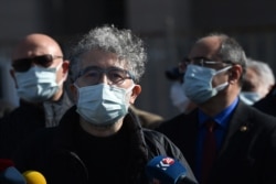 FILE - Turkish-French journalist Erol Onderoglu, Reporters Without Borders representative in Turkey, speaks to the press before his trial for "terrorist propaganda," in front of Istanbul's courthouse building, Feb. 3, 2021.