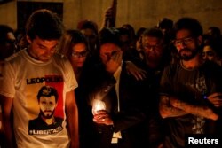 FILE - Lawmakers from the Venezuelan coalition of opposition parties Juan Andres Mejia, left, First Vice-President of the National Assembly Freddy Guevara, center, and Miguel Pizarro attend an event in honor of 17-year-old protester Neomar Lander, who died during clashes with security forces in Caracas, Venezuela, June 8, 2017.