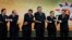 Brunei Sultan Hassanal Bolkiah, left, and other leaders of the Association of Southeast Asian Nations join their hands for a group photo section during the 22nd ASEAN Summit in Bandar Seri Begawan, Brunei, Thursday, April 25, 2013. They are, from left, Bo