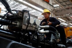 An employee works at a manufacturing plant of Sany Heavy Industry Co. during a government-organized tour of manufacturers based in Changsha, Hunan province, China, Oct. 19, 2019.