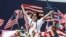 FILE — A man waves an American flag during a during a rally in Atlanta, Georgia.