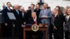 FILE - President Donald Trump, Canada's Prime Minister Justin Trudeau, right, and Mexico's then-President Enrique Pena Nieto, left, participate in the USMCA signing ceremony, Nov. 30, 2018, in Buenos Aires. Trump will sign U.S. legislation Wednesday.