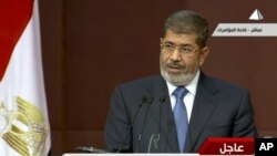 In this image from a live broadcast on Egyptian State Television, Egyptian President Mohammed Morsi speaks to the constituent assembly in Cairo on Dec. 1, 2012.