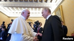 FILE - Russian President Vladimir Putin meets with Pope Francis at the Vatican, July 4, 2019. 