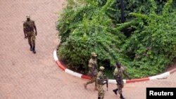 FILE - Presidential guard soldiers are seen on the grounds of the Laico Hotel in Ouagadougou, Burkina Faso, Sept. 20, 2015.