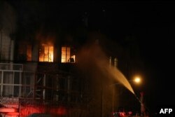 Water is sprayed on a fire set at the Saudi Embassy in Tehran during a demonstration against the execution of prominent Shiite Muslim cleric Nimr al-Nimr by Saudi authorities, Jan. 2, 2016.