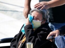 A woman wipes away tears as people pay respects to Justice Ruth Bader Ginsburg as she lies in repose in front of the US Supreme Court in Washington, DC on September 23, 2020.