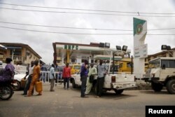 People queue with their vehicles to buy fuel at a fuel station in Agege district in Lagos, Nigeria, April 5, 2016.