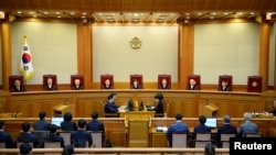South Korean acting Constitutional Court's Chief Judge Lee Jung-mi (center) and seven judges during final ruling of President Park Geun-hye's impeachment at the Constitutional Court in Seoul, South Korea, March 10, 2017.