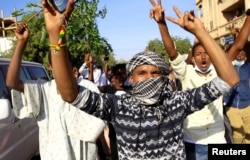 Demonstrators chant slogans as they march along the street during anti-government protests in Khartoum, Sudan, Dec. 25, 2018.