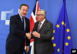 European Commission President Jean-Claude Juncker, right, greets British Prime Minister David Cameron prior to a meeting at EU headquarters in Brussels on June 28, 2016.