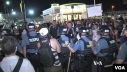 Police gather on street in Ferguson, Missouri, Aug. 10, 2015. (Photo: Kane Farabaugh / VOA)