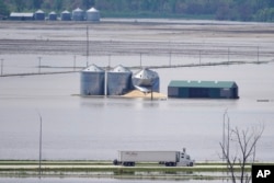 FILE - Grain bins stand in floodwaters from the Missouri River, in Hamburg, Iowa, May 10, 2019.