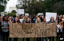 Activists demonstrate on the lawn of the East Front of the U.S. Capitol to protest the confirmation vote of Supreme Court nominee Brett Kavanaugh on Capitol Hill, Oct. 6, 2018, in Washington.