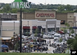 FILE - Authorities investigate a shooting in the parking lot of Twin Peaks restaurant in Waco, Texas. An indictment announced by the U.S. Attorney's Office in San Antonio accuses three Bandidos leaders of sanctioning a three-year fight that included viole
