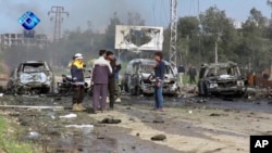 This frame grab from video provided by the Thiqa News Agency shows rebel gunmen at the site of a blast that damaged several buses and vans at the Rashideen area, a rebel-controlled district outside Aleppo city, Syria, April. 15, 2017.