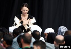 New Zealand's Prime Minister Jacinda Arden gestures to relatives of victims of the mosque attacks during the national remembrance service, at Hagley Park in Christchurch, New Zealand, March 29, 2019.