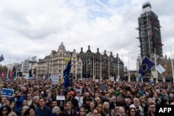 Crowds gather after the march to listen to speakers at a rally organized by the pro-European People's Vote campaign for a second EU referendum in Parliament Square, central London, March 23, 2019.
