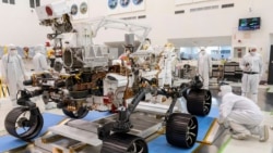 In this Dec. 17, 2019 file photo made available by NASA, engineers monitor a driving test for the Mars rover Perseverance in a clean room at the Jet Propulsion Laboratory in Pasadena, Calif. (J. Krohn/NASA via AP, File)