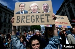 FILE - People hold banners during a 'March for Europe' demonstration against Britain's decision to leave the European Union, in central London, Britain, July 2, 2016.