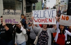 FILE - Participants march against sexual assault and harassment at the #MeToo March in the Hollywood section of Los Angeles, Nov. 12, 2017.