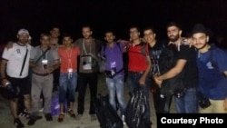 After the harrowing voyage across the Mediterranean, the group poses for a photo on the Greek island of Lesbos, Sept. 2015.