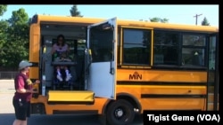 A Metropolitan Transportation Network bus picks up students for summer school in Minnesota, Aug. 8, 2017.