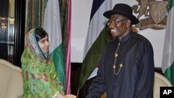 FILE - Malala Yousafzai shakes hands with Nigerian President, Goodluck Jonathan, in Abuja, July 14, 2014.