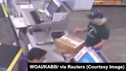 A surveillance image shows the serial bombing suspect inside a FedEx office store in Austin, Texas, which was given to law enforcement and obtained by TV station, WOAI/KABB, March 21, 2018.