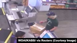 A surveillance image shows the serial bombing suspect inside a FedEx office store in Austin, Texas, which was given to law enforcement and obtained by TV station, WOAI/KABB, March 21, 2018.